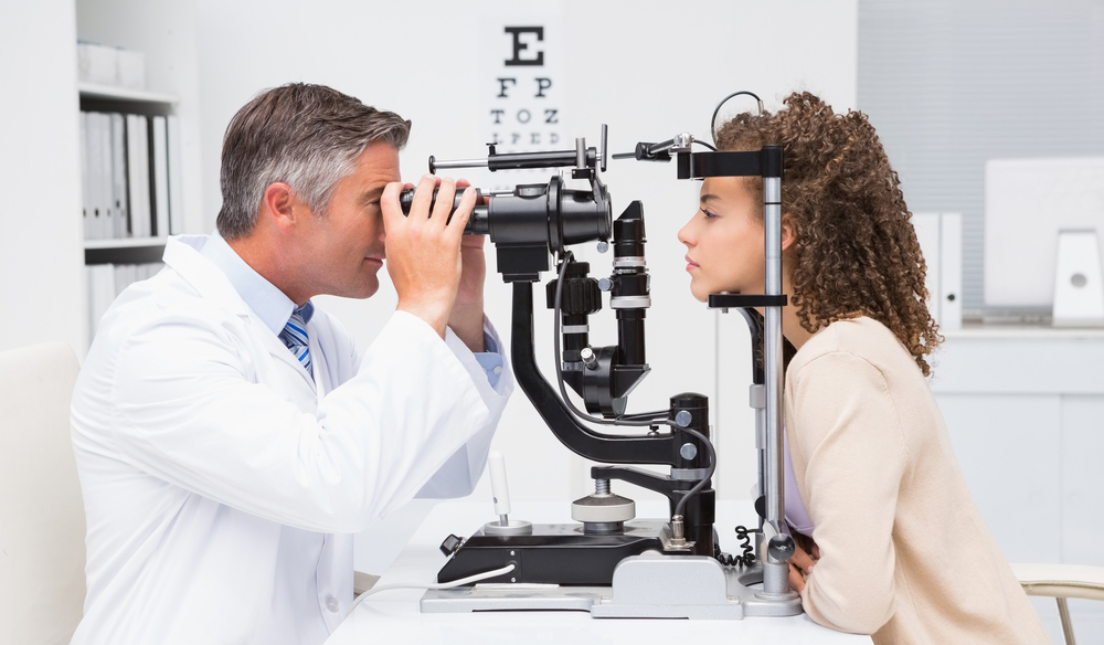 An optometrist performing an eye exam when starting with lenses